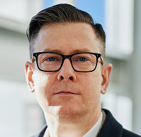 Portrait of Alexander Hughes, CEO and crypto trading company executive